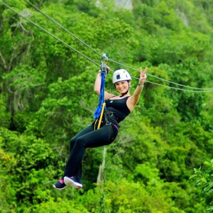 a peron in a zip line in hacienda with a nature background